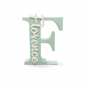 A mint green decorative block letter 'F' with the word 'Florence' in white cursive script running vertically through the center, shown on a plain white background.