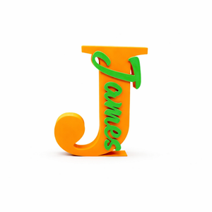 A 3D decorative block letter 'J' in bright orange, with the name 'James' written vertically in green script, shown on a clean white background.
