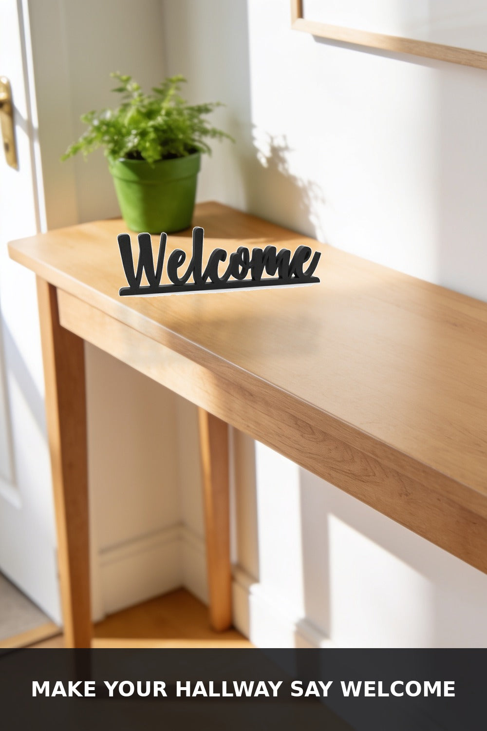 Black 3D printed Welcome word sign on a wooden hallway console table with the caption Make Your Hallway Say Welcome