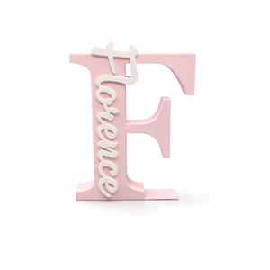 A pink decorative block letter 'F' with the word 'Florence' written vertically in white script, shown on a clean white background.