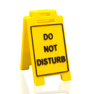 Do Not Disturb mini floor sign in yellow and black on an office desk